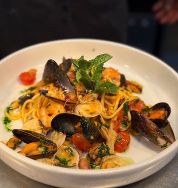 a plate of pasta with musselling and musselling