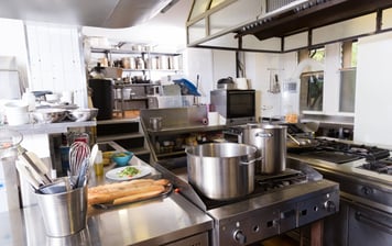 a kitchen with a stove top and a potted potted with bread