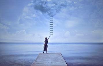 person reaching for a staircase leading to the sky