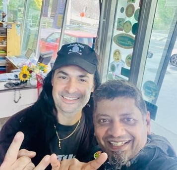 Gas station owner and rock band front man helping fix my motorcycle in Italy