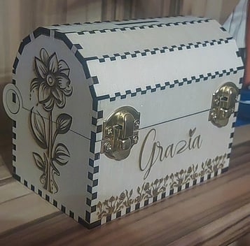 Eine Holzkiste mit Blumenmuster und dem Namen Grazia auf der Vorderseite