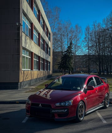 A red car parked in a parking lot