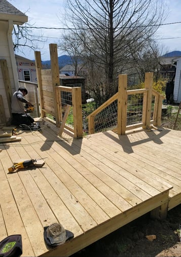 construction worker installing fencing for a newly constructed porch for a home in Hickory, NC