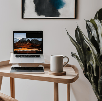 a laptop computer sitting on a table with a cup of coffee