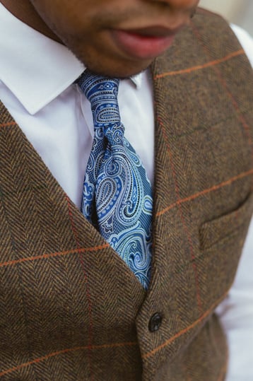 "Personal stylist sitting showing men tie"