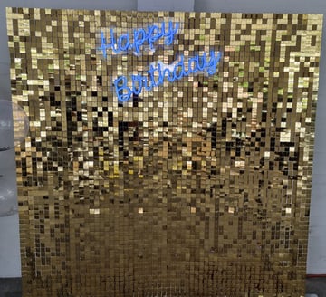 Gold shimmer wall set up at Tipene's daughters 10th birthday with a blue Happy Birthday neon in Logan