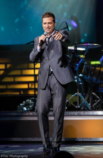 Scott Keo pointing to hi audience, at his World Renown Michael Buble' Tribute Artist Singer Show