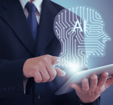 A business leader in a suit works on his tablet computer, with a holographic AI head emerging from the screen, face unseen.
