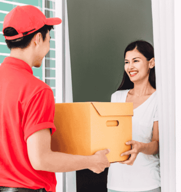 a man and woman holding a box of boxes