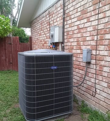 a large air conditioner sitting on the side of a brick building