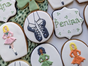 Cookies with Irish step dance theme with dancers, shoes, shamrocks in various colors