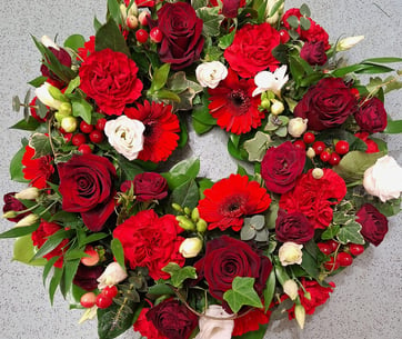 Red rose and gerbera funeral wreath