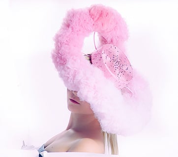 a woman with a pink feathered hat