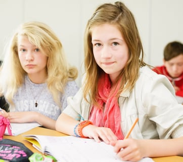 3 children at a desk working