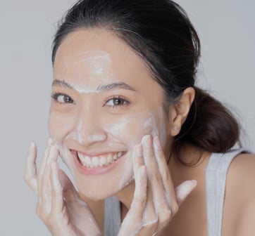 Young woman washing her face