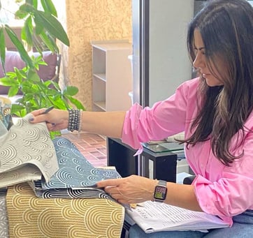 Sigal, founder of Solo Home Decor, selects fabrics while designing custom furniture.