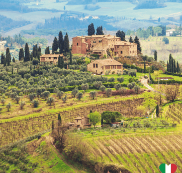 a small village in italy with a flag on the top of the hill