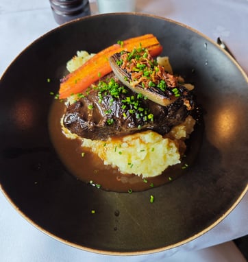 Beef main course on dark plate