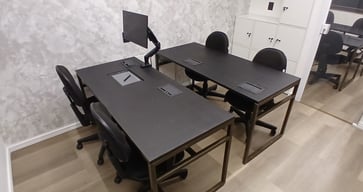 a desk with a computer monitor and a monitor