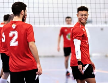 a group of men playing volleyball