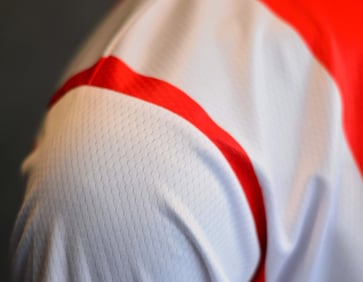 a close up of a man's shirt with a red and white shirt