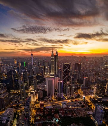 a cityscape of a city at sunset