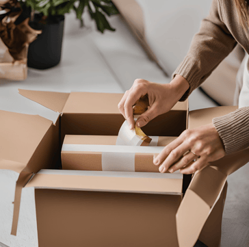a woman is putting a piece of paper in a box