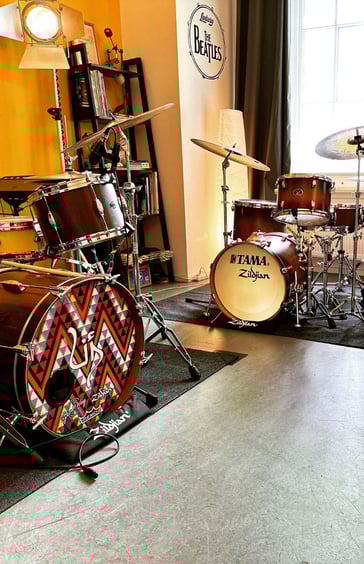 a drum kit with drums and drums in a room