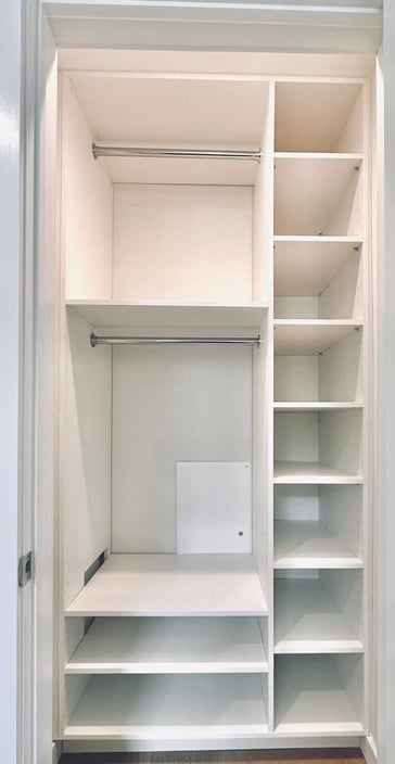 a closet with a laptop computer and a laptop