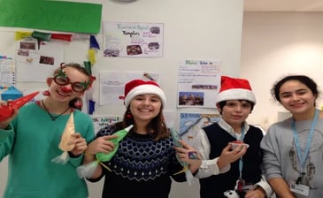 a group of students wearing santa claus claus hats