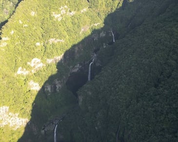 a succession of waterfall in the middle of a mountain
