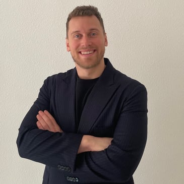 a man in a suit and tie smiling