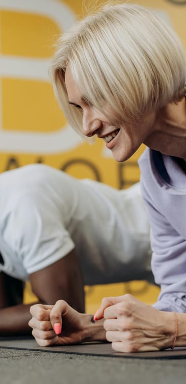 a woman is doing push ups on a mat