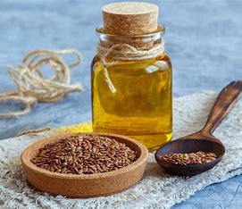 flax seeds oil and flax seeds in a wooden bowl