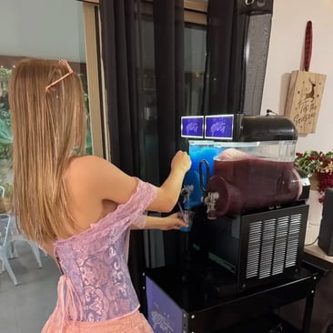 Liv filling up her cup of ice cold blue raspberry from the slushie machine in Mount Cotton.