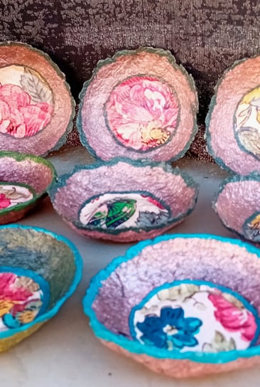 a group of vibrant color bowls with old paperwall