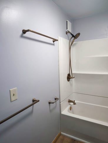 This remodeled bathroom in Goshen, IN has a grab bar and towel bars along with a new bathtub.