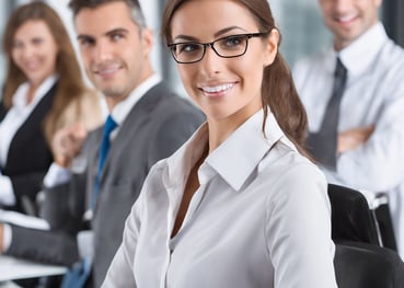 a woman in a white shirt and glasses is standing in front of a group of