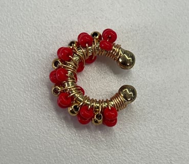 a red beaded bracelet with gold and red beads