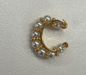 a pearled hoop earring with pearls and gold