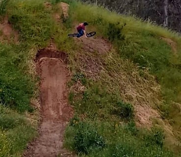 Rider turning mid-air on a hip jump, angling sideways