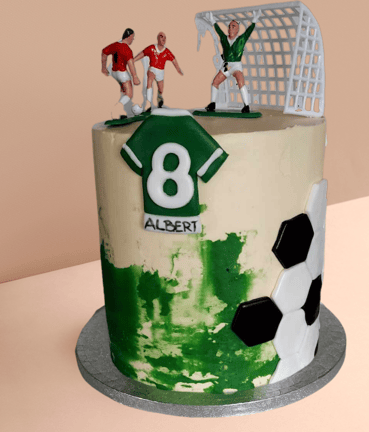 a cake with a soccer player and a soccer player