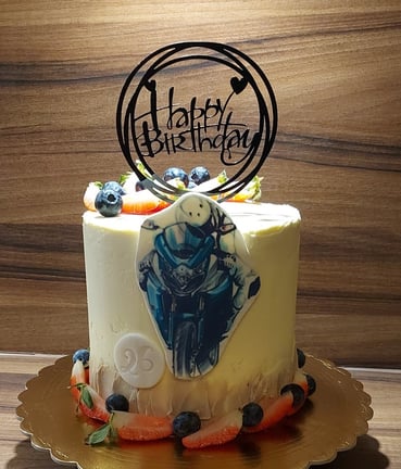 a cake with a motorcycle themed cake topper