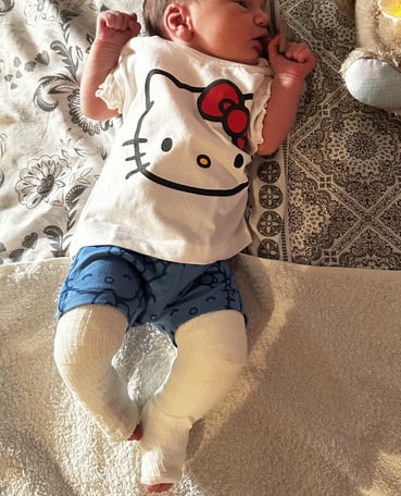 a baby is laying on a blanket on a bed