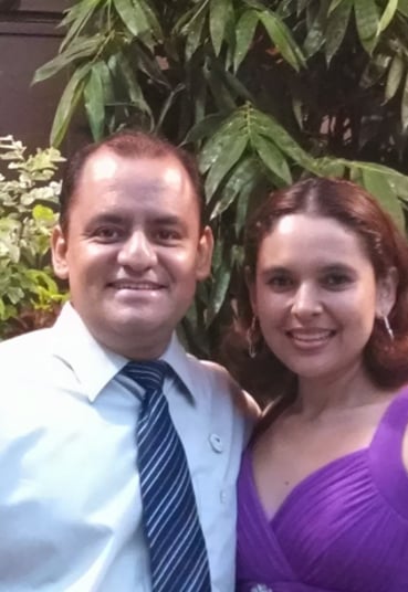 a man and woman standing in front of a building
