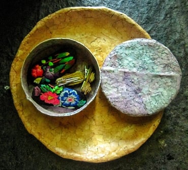 Recycled paper purple jewelry case opened on recycle paper brown plae