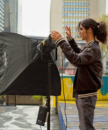 Youth setting up a video light