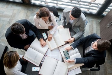 Business hands coordinating offer documents for export – Zyncopra trade communication