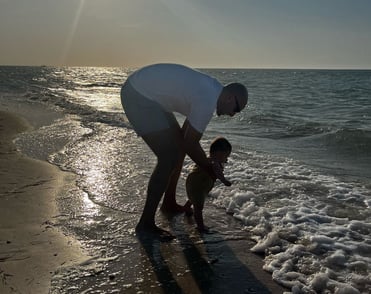a man and his baby playing in the water