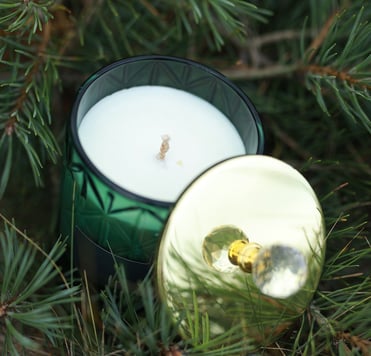a candle with a candle in a glass jar